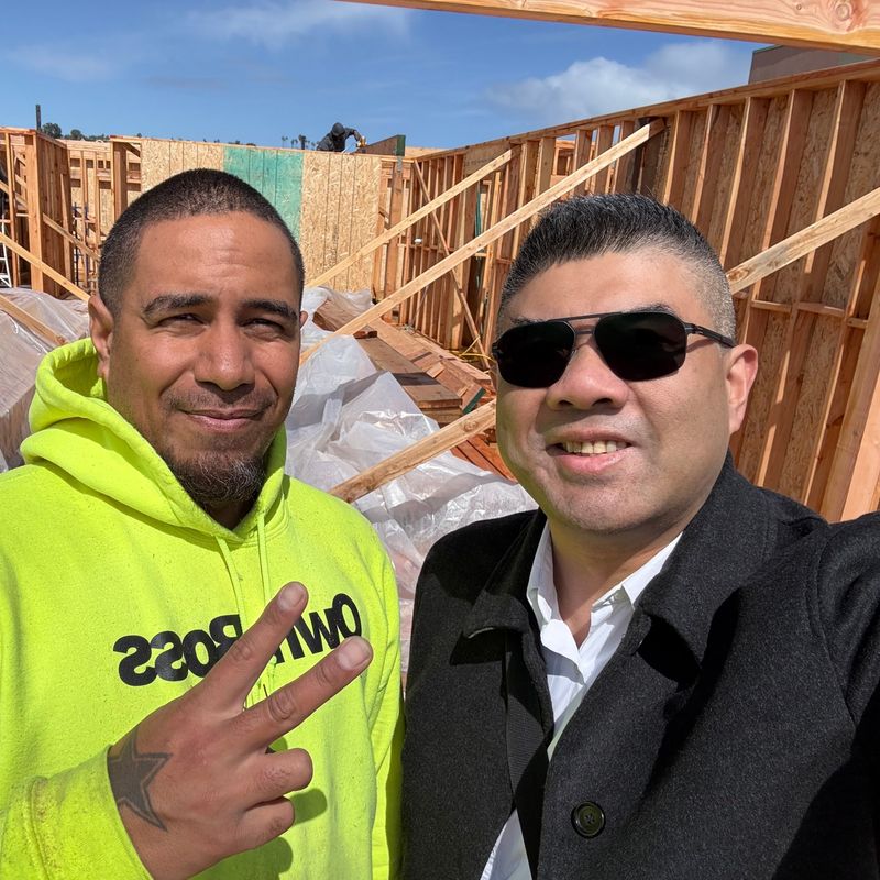 Kyle Chuang with a builder on a site walk